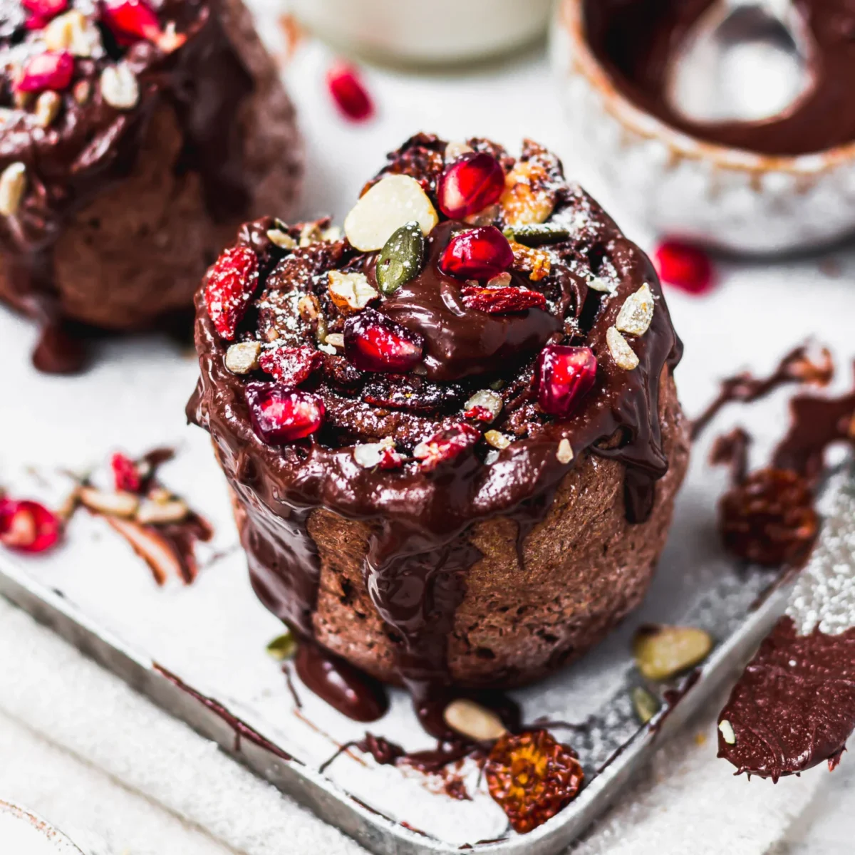 Photo shows a double chocolate "fruit and nut swirl" decorated with pomegranite and other seeds.