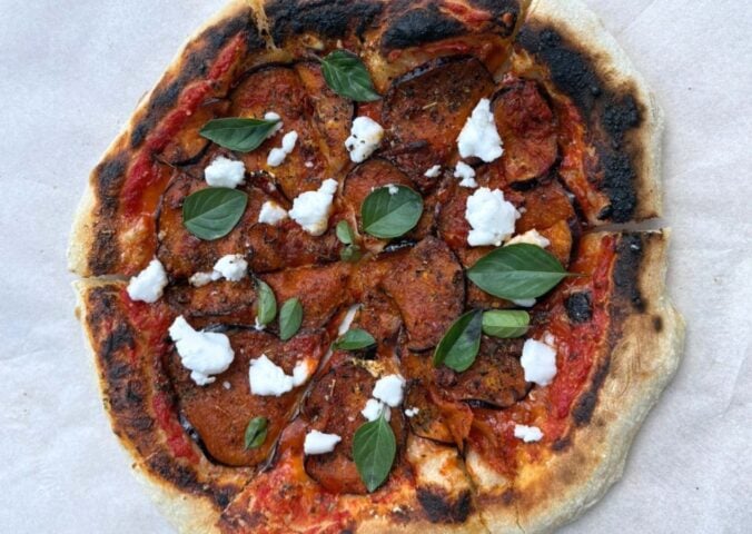 A vegan aubergine and harissa pizza with dairy-free feta cheese